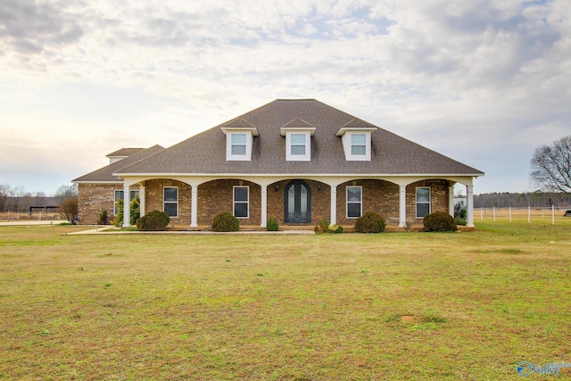 cape cod-style house with covered porch and a front lawn