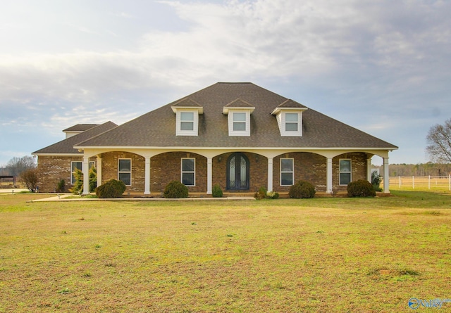 view of front of house with a porch and a front lawn