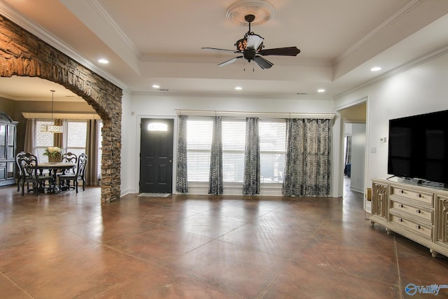 living room featuring crown molding, a tray ceiling, and ceiling fan