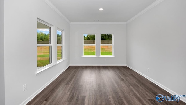 empty room featuring dark hardwood / wood-style floors, a healthy amount of sunlight, and ornamental molding