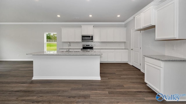 kitchen featuring dark hardwood / wood-style flooring, white cabinetry, a kitchen island with sink, and appliances with stainless steel finishes