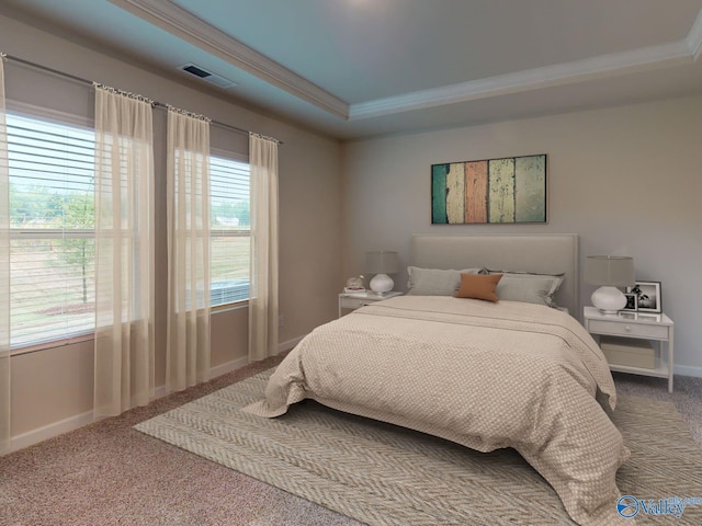 carpeted bedroom with ornamental molding, a raised ceiling, visible vents, and baseboards