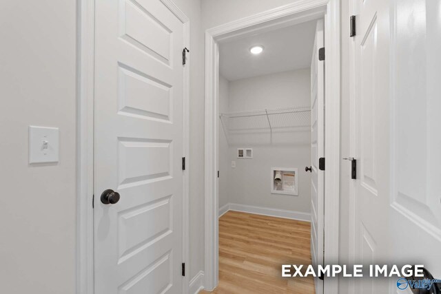 clothes washing area featuring light wood finished floors, baseboards, visible vents, hookup for a washing machine, and laundry area