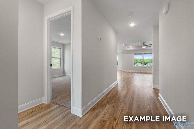 hall featuring recessed lighting, wood finished floors, and baseboards