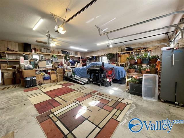 garage with a ceiling fan and refrigerator