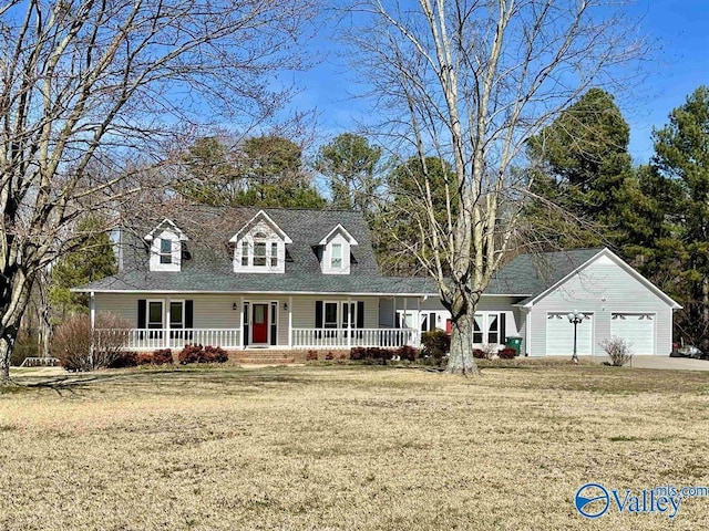 new england style home with a front yard, driveway, a porch, and a garage