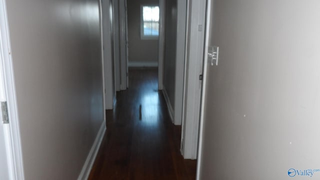 hallway with dark hardwood / wood-style flooring