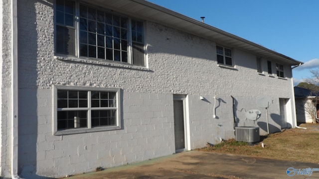 view of side of home featuring central AC