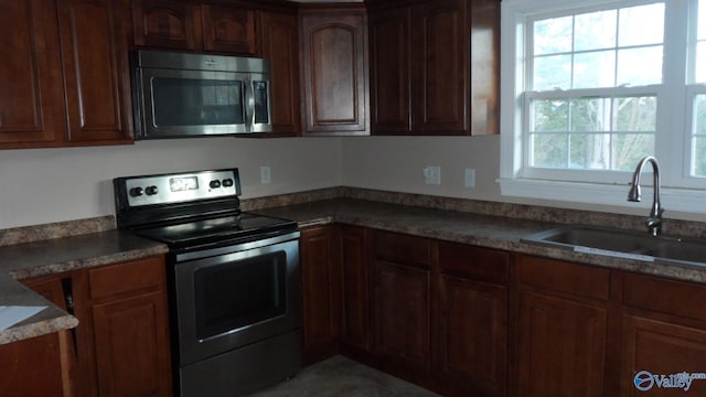 kitchen with a wealth of natural light, sink, and appliances with stainless steel finishes