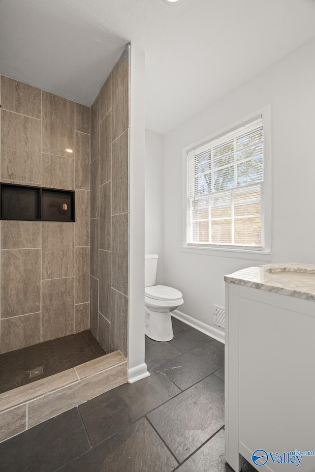 10012 Allison Dr, Huntsville, AL 35803 - full bath with tiled shower, toilet, baseboards, and vanity