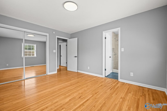 10012 Allison Dr, Huntsville, AL 35803 - unfurnished bedroom with light wood-type flooring, baseboards, a closet, and connected bathroom