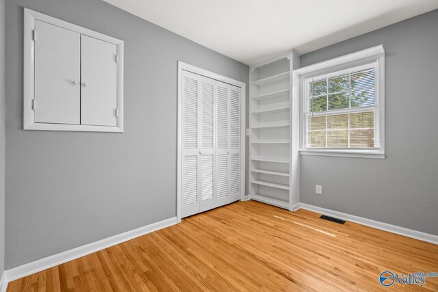 10012 Allison Dr, Huntsville, AL 35803 - unfurnished bedroom featuring light wood finished floors, baseboards, and a closet