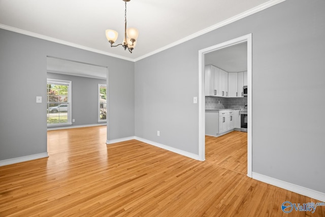 10012 Allison Dr, Huntsville, AL 35803 - unfurnished room with a chandelier, light wood-type flooring, crown molding, and baseboards