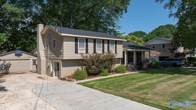 10012 Allison Dr, Huntsville, AL 35803 - split level home with an outbuilding, a chimney, concrete driveway, a garage, and a front lawn