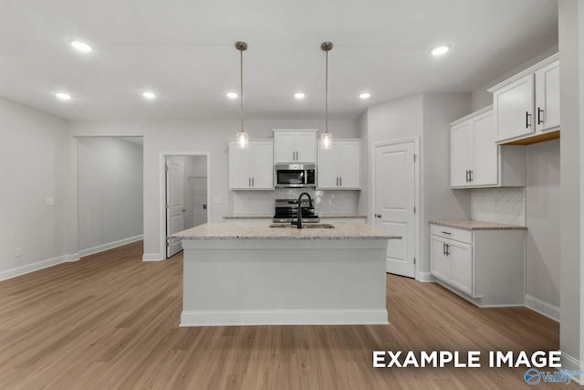 433 Lando Cain Rd, Hartselle, AL 35640 - kitchen featuring stainless steel microwave, a sink, backsplash, baseboards, and recessed lighting