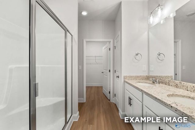 433 Lando Cain Rd, Hartselle, AL 35640 - full bath with a stall shower, wood finished floors, double vanity, a spacious closet, and baseboards