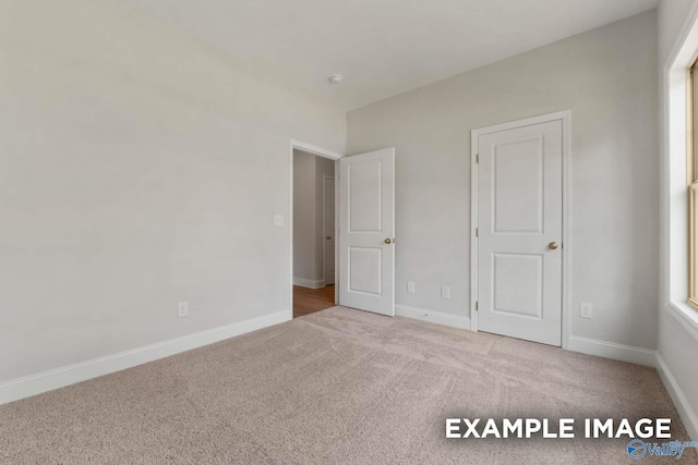 433 Lando Cain Rd, Hartselle, AL 35640 - unfurnished bedroom featuring carpet floors and baseboards