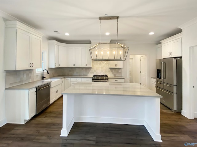 kitchen with premium appliances, a center island, dark hardwood / wood-style floors, hanging light fixtures, and decorative backsplash