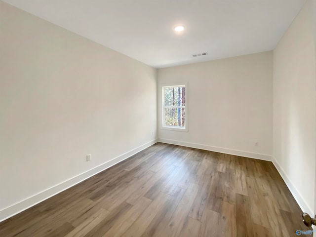 unfurnished room with hardwood / wood-style flooring