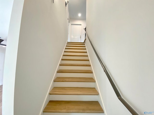 stairway featuring hardwood / wood-style flooring