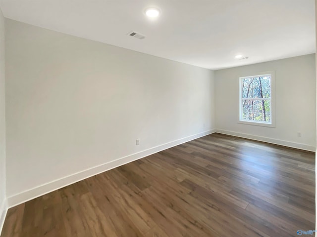 unfurnished room featuring dark wood-type flooring