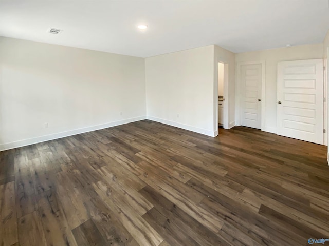 spare room with dark hardwood / wood-style floors