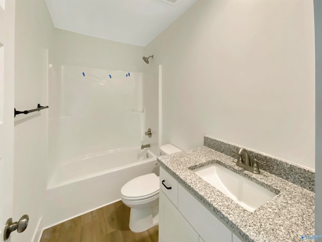 full bathroom featuring vanity, toilet, bathtub / shower combination, and hardwood / wood-style floors