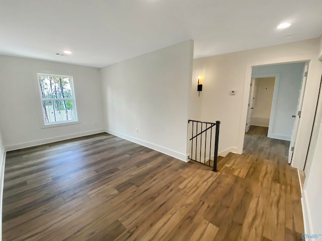 unfurnished room with dark hardwood / wood-style floors