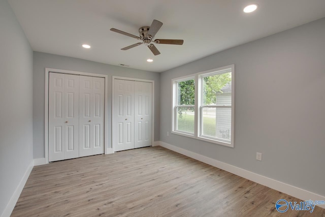 3913 Pine Ave SW, Huntsville, AL 35805 - unfurnished bedroom with multiple closets, baseboards, and wood finished floors