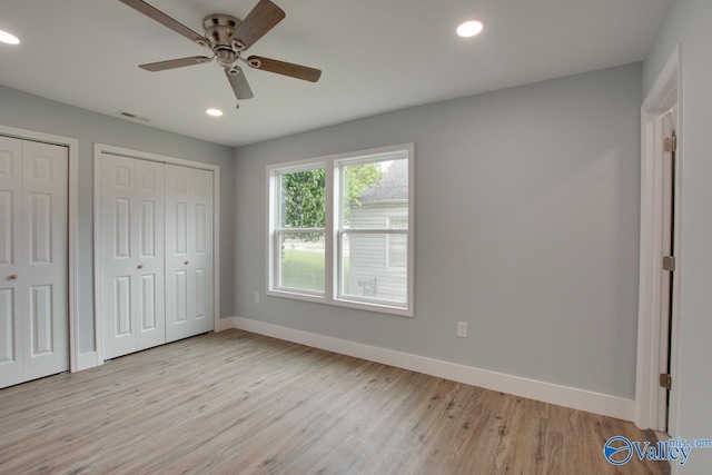 3913 Pine Ave SW, Huntsville, AL 35805 - unfurnished bedroom with visible vents, baseboards, multiple closets, recessed lighting, and light wood-style flooring