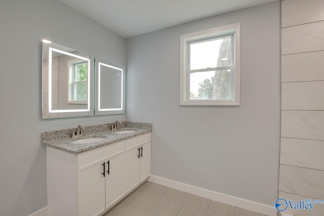 3913 Pine Ave SW, Huntsville, AL 35805 - full bath with a sink, double vanity, and a wealth of natural light