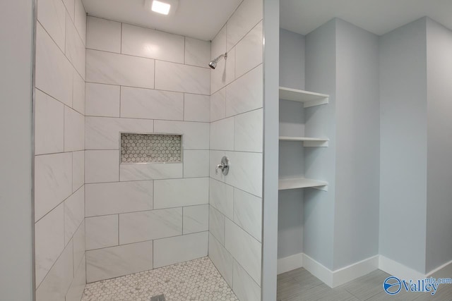 3913 Pine Ave SW, Huntsville, AL 35805 - bathroom with baseboards and a tile shower