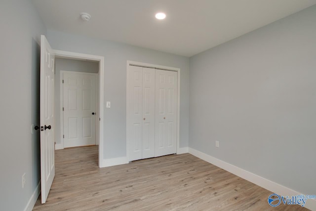 3913 Pine Ave SW, Huntsville, AL 35805 - unfurnished bedroom featuring light wood-style floors, baseboards, a closet, and recessed lighting