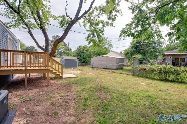 3913 Pine Ave SW, Huntsville, AL 35805 - view of yard featuring stairs, a shed, a deck, a fenced backyard, and an outbuilding