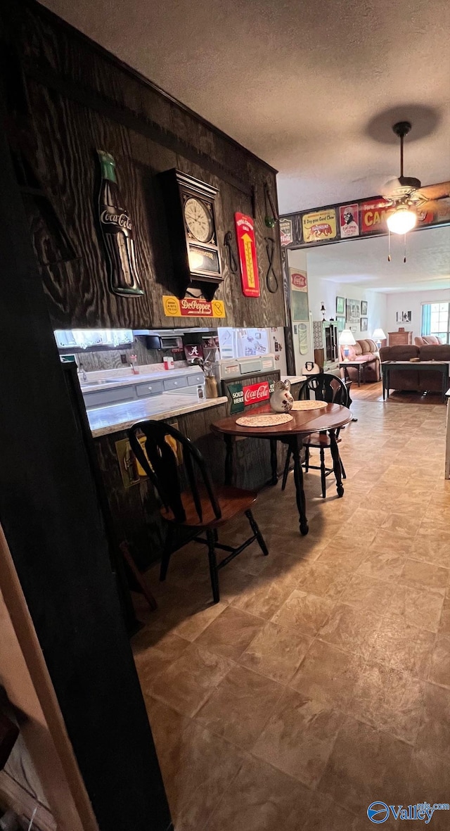 dining area featuring light tile patterned flooring, a textured ceiling, and ceiling fan