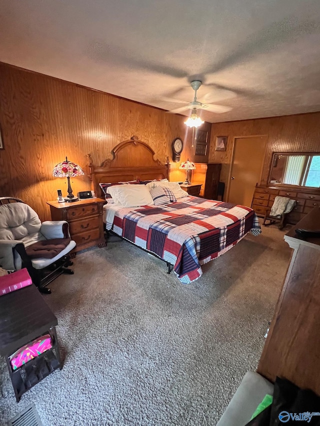 bedroom featuring carpet floors, ceiling fan, and wooden walls