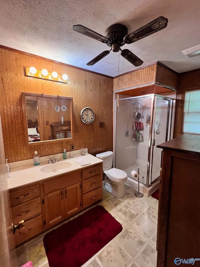 bathroom featuring tile patterned flooring, an enclosed shower, toilet, vanity, and ceiling fan