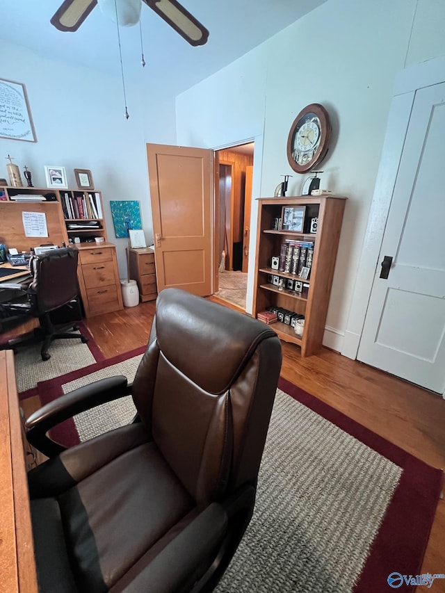 office with wood-type flooring and ceiling fan