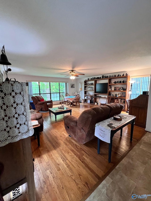 living room featuring hardwood / wood-style floors and ceiling fan