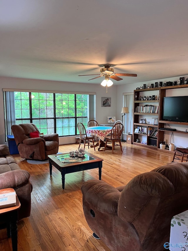 living room featuring plenty of natural light, ceiling fan, and hardwood / wood-style flooring