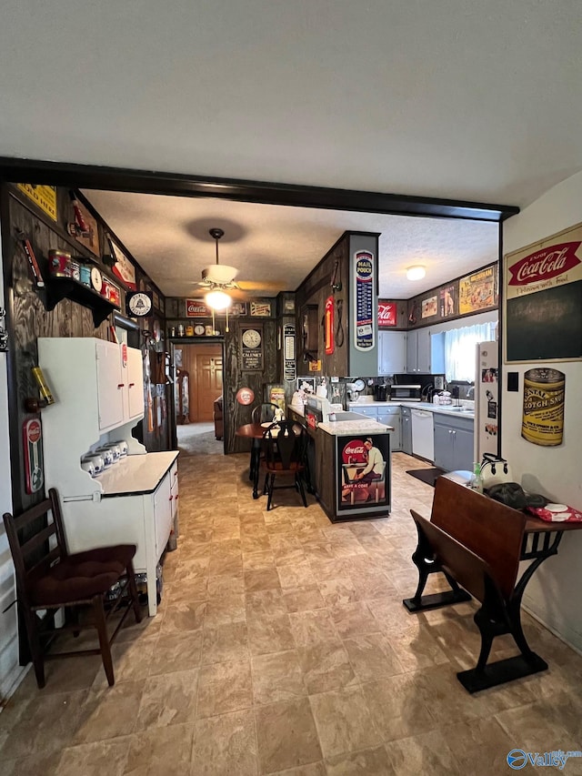 tiled living room with ceiling fan