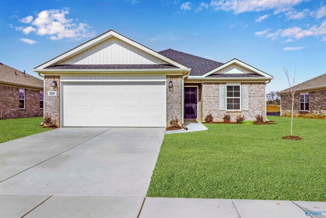 view of front of property with a garage and a front lawn