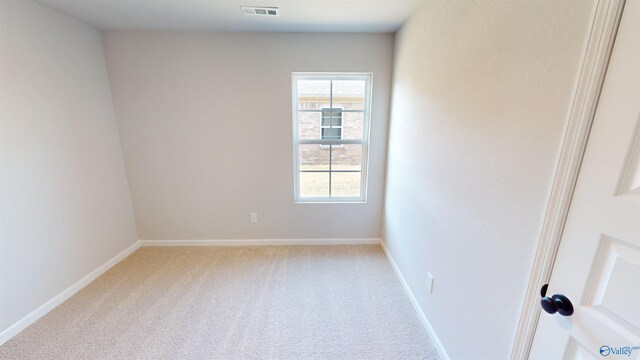 unfurnished room with light carpet