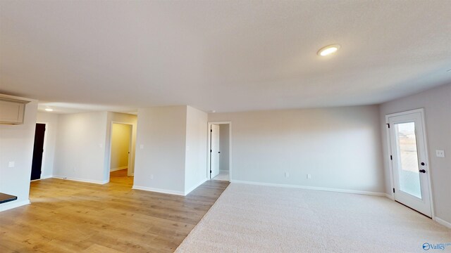 empty room with light hardwood / wood-style flooring