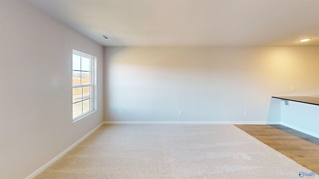 spare room with light hardwood / wood-style flooring