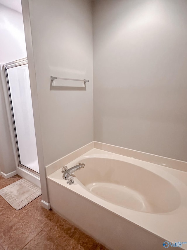 bathroom featuring tile patterned flooring and shower with separate bathtub