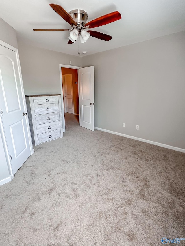 unfurnished bedroom featuring ceiling fan and light carpet