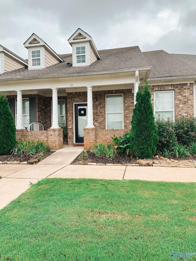 view of front of home featuring a porch and a front yard