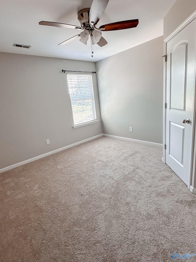 carpeted empty room with ceiling fan