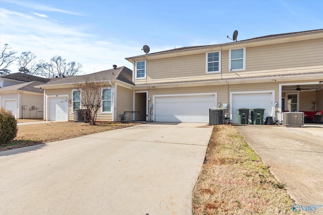 view of front of home featuring a garage and central air condition unit